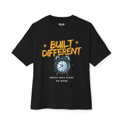 Built Different Alarm Clock Tee — "Built Different: While They Sleep We Work" Motivational T‑Shirt